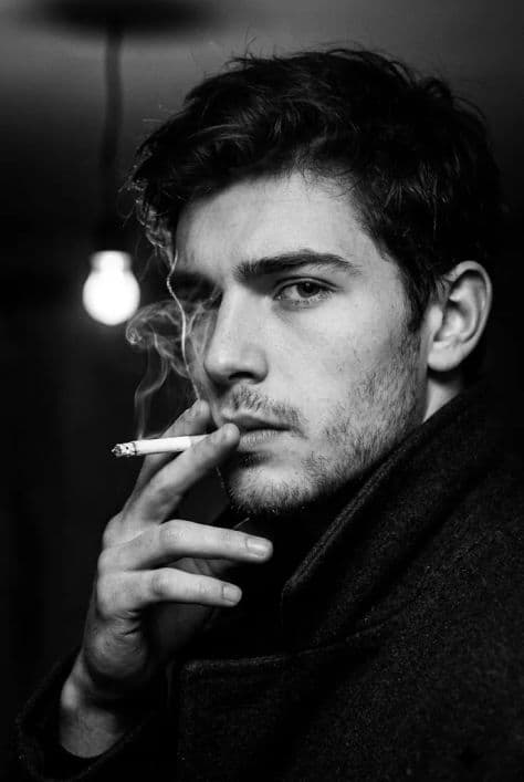 Portrait — Midjourney Portrait prompt. Cinematic black-and-white extreme close-up of a man in a dark back room, vertica | PromptLabHub
